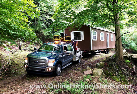 A Hickory Shed being towed through the woods